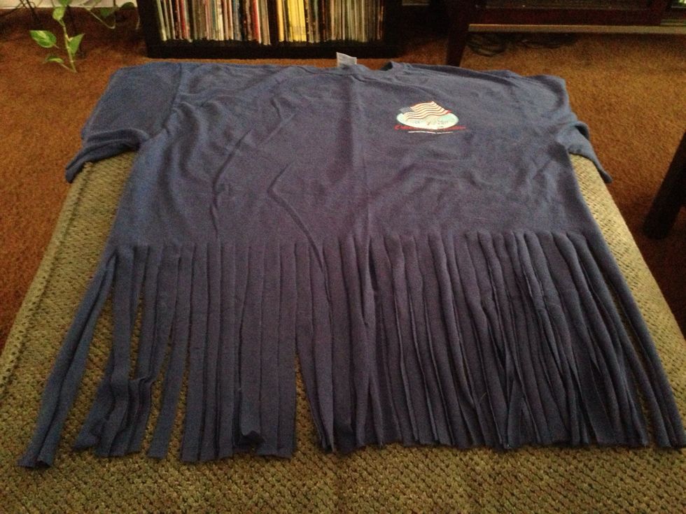 Your shirt should look like this. Remember be creative! You can cut higher or go back later and tie knots on the bottom of each strip or add beads.