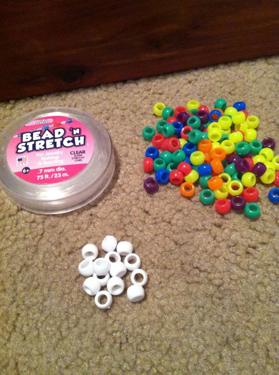 Your supplies are string, white beads, and a whole lotta neon beads.